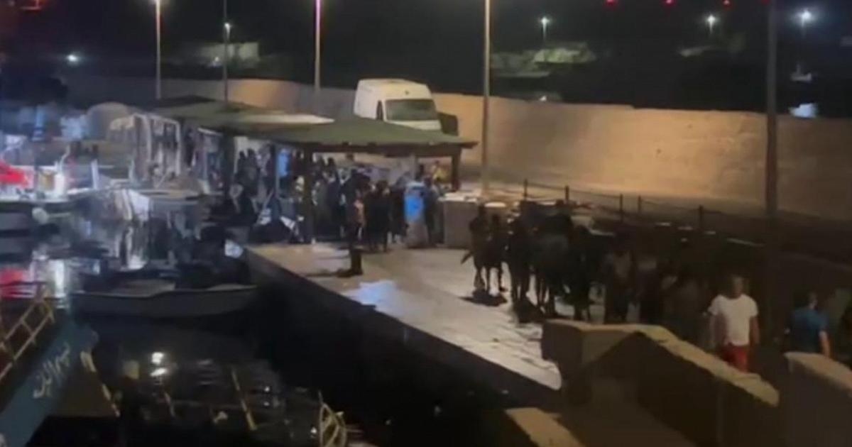 Survivors of the shipwreck off Lampedusa arrive at the Favarolo dock.